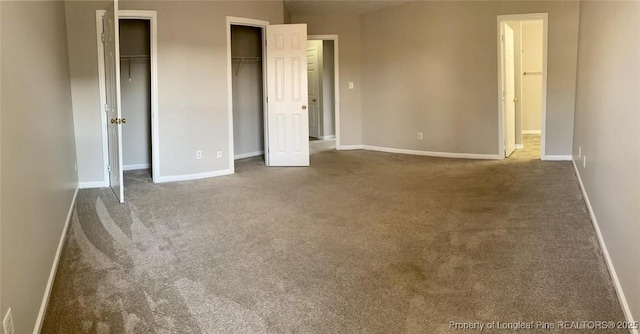 5566 Robmont Dr, Fayetteville, NC 28306 - unfurnished bedroom featuring two closets and carpet