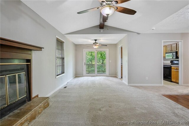 303 Whipple Tree Ln, Fayetteville, NC 28314 - unfurnished living room featuring a glass covered fireplace, a ceiling fan, and light carpet