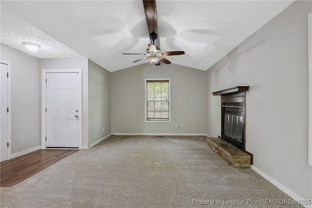 303 Whipple Tree Ln, Fayetteville, NC 28314 - unfurnished living room featuring carpet flooring, a glass covered fireplace, ceiling fan, and vaulted ceiling