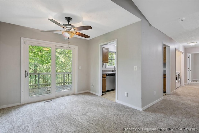 303 Whipple Tree Ln, Fayetteville, NC 28314 - spare room with light colored carpet, a ceiling fan, washer and clothes dryer, and a smoke detector