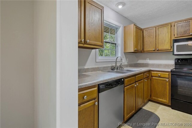 303 Whipple Tree Ln, Fayetteville, NC 28314 - kitchen with black electric range oven, stainless steel dishwasher, light countertops, a textured ceiling, and brown cabinets