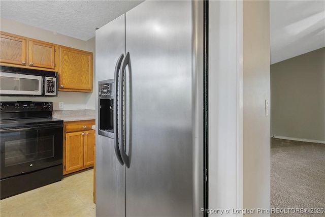 303 Whipple Tree Ln, Fayetteville, NC 28314 - kitchen with stainless steel fridge, electric range, light countertops, and a textured ceiling