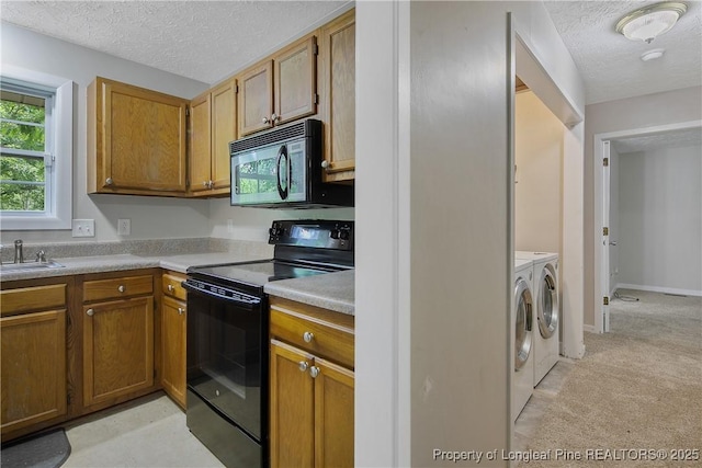 303 Whipple Tree Ln, Fayetteville, NC 28314 - kitchen featuring black appliances, washer and clothes dryer, a textured ceiling, light carpet, and light countertops
