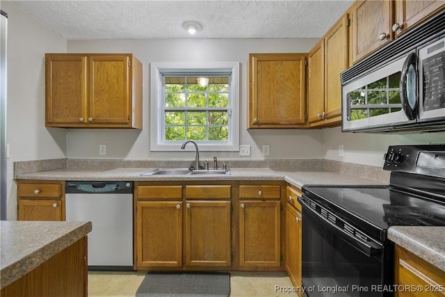 303 Whipple Tree Ln, Fayetteville, NC 28314 - kitchen with stainless steel dishwasher, black electric range, brown cabinets, a textured ceiling, and light countertops