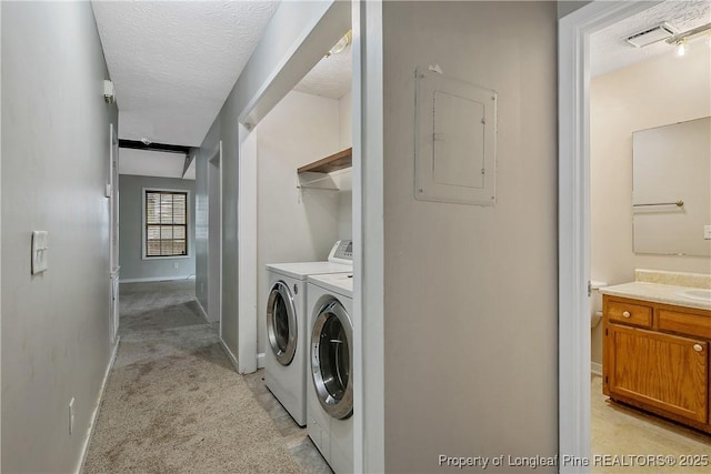 303 Whipple Tree Ln, Fayetteville, NC 28314 - washroom featuring electric panel, washer and clothes dryer, a textured ceiling, and light carpet