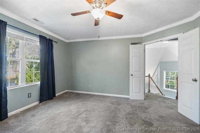 7616 Spurge Dr, Fayetteville, NC 28311 - carpeted empty room featuring healthy amount of natural light, crown molding, and a ceiling fan