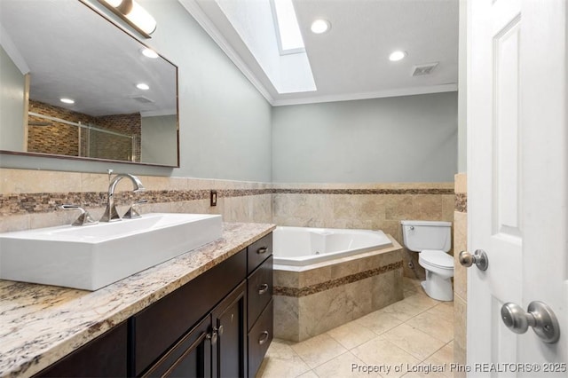7616 Spurge Dr, Fayetteville, NC 28311 - full bath with a skylight, a whirlpool tub, tile patterned flooring, vanity, and tiled shower