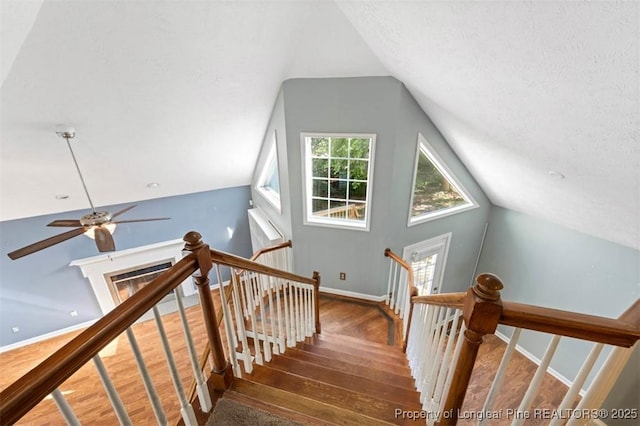 7616 Spurge Dr, Fayetteville, NC 28311 - stairs with wood-type flooring, lofted ceiling, and ceiling fan