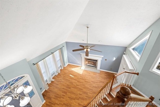 7616 Spurge Dr, Fayetteville, NC 28311 - staircase with plenty of natural light, ceiling fan, wood finished floors, lofted ceiling, and a fireplace with flush hearth