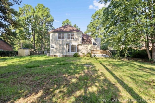7616 Spurge Dr, Fayetteville, NC 28311 - rear view of house with a storage shed, a chimney, and a deck