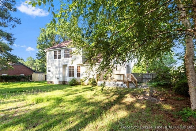7616 Spurge Dr, Fayetteville, NC 28311 - rear view of property with a wooden deck and a storage unit