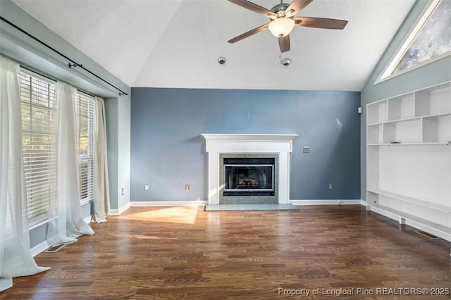 7616 Spurge Dr, Fayetteville, NC 28311 - unfurnished living room with high vaulted ceiling, healthy amount of natural light, ceiling fan, a high end fireplace, and wood finished floors