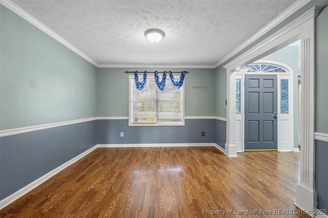 7616 Spurge Dr, Fayetteville, NC 28311 - entryway with wood finished floors, a textured ceiling, and ornamental molding