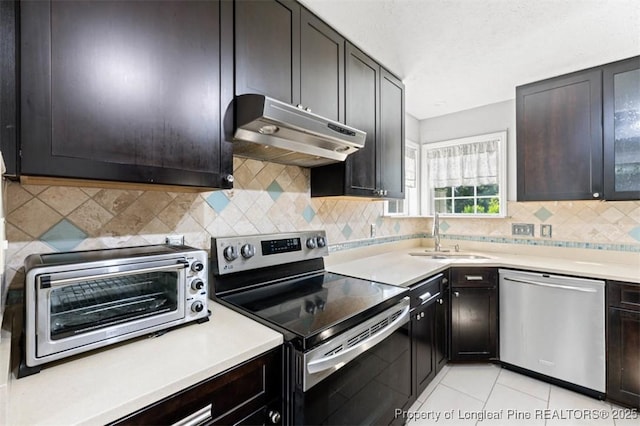 7616 Spurge Dr, Fayetteville, NC 28311 - kitchen with stainless steel appliances, under cabinet range hood, light countertops, and tasteful backsplash