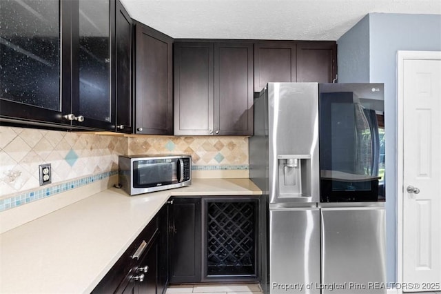 7616 Spurge Dr, Fayetteville, NC 28311 - kitchen featuring stainless steel appliances, light countertops, backsplash, and glass insert cabinets