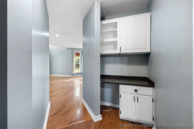 7616 Spurge Dr, Fayetteville, NC 28311 - corridor featuring dark wood-style floors and a textured ceiling