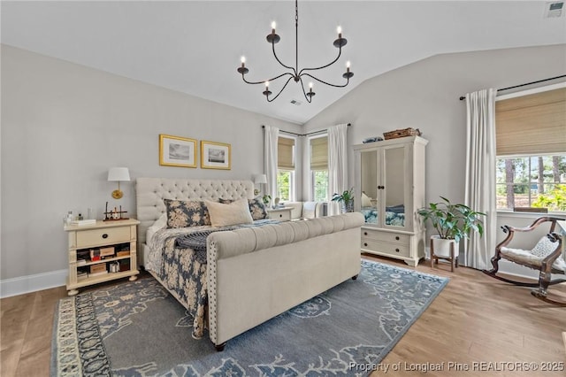 500 Legacy Lakes Way, Aberdeen, NC 28315 - bedroom with lofted ceiling, a chandelier, wood finished floors, and multiple windows