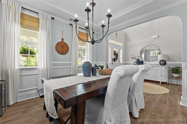 500 Legacy Lakes Way, Aberdeen, NC 28315 - dining space with a chandelier, ornamental molding, a wainscoted wall, healthy amount of natural light, and dark wood-style flooring