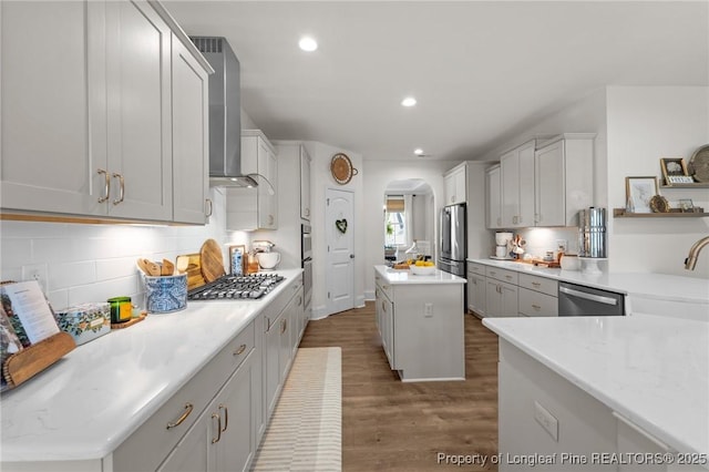 500 Legacy Lakes Way, Aberdeen, NC 28315 - kitchen with appliances with stainless steel finishes, wall chimney range hood, arched walkways, wood finished floors, and recessed lighting