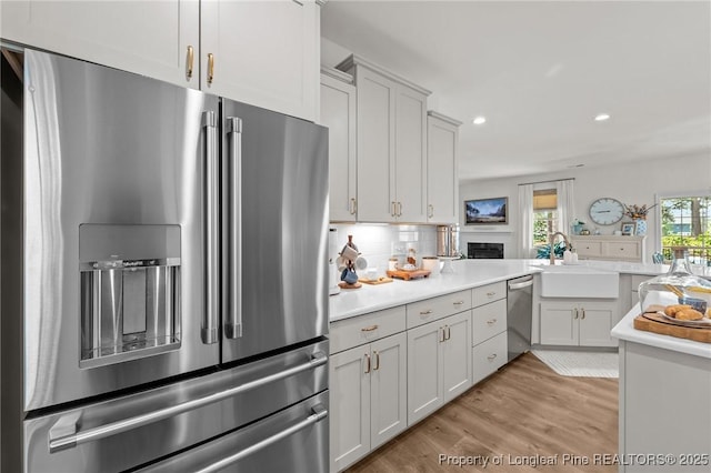500 Legacy Lakes Way, Aberdeen, NC 28315 - kitchen with stainless steel appliances, light countertops, light wood-style floors, decorative backsplash, and recessed lighting