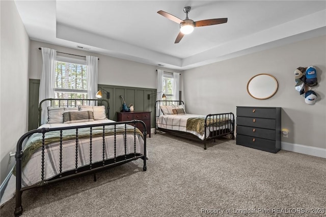 500 Legacy Lakes Way, Aberdeen, NC 28315 - bedroom with a tray ceiling, carpet, and a ceiling fan