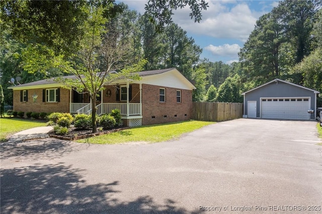 ranch-style house with crawl space, covered porch, a detached garage, and brick siding