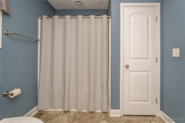 full bathroom featuring a shower with shower curtain and tile patterned flooring
