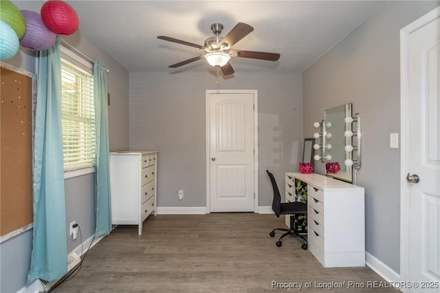 home office with wood finished floors and a ceiling fan