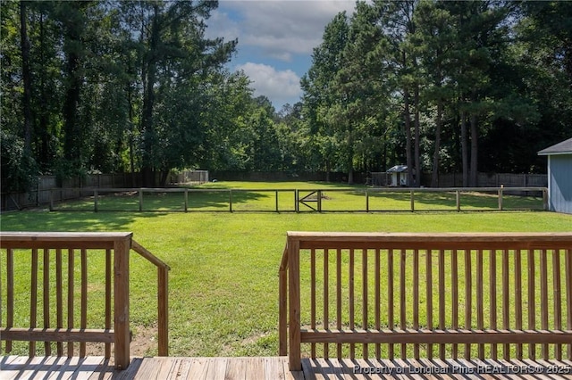 fenced backyard featuring a gate and a shed