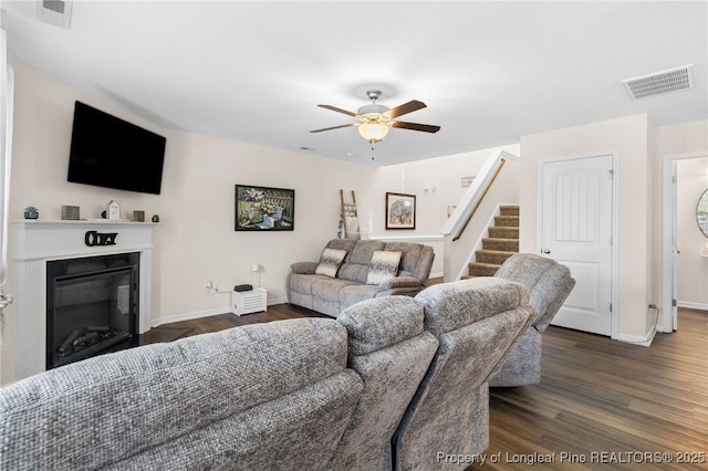 1206 Coot Ct, Hope Mills, NC 28348 - living room with a ceiling fan, a glass covered fireplace, dark wood-style floors, and stairs
