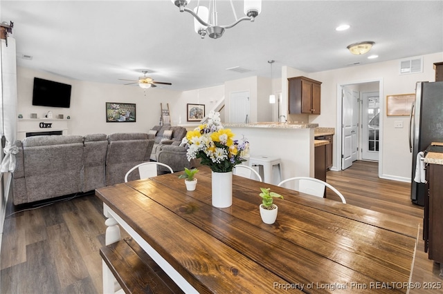 1206 Coot Ct, Hope Mills, NC 28348 - dining room featuring dark wood-style flooring, ceiling fan, and a chandelier