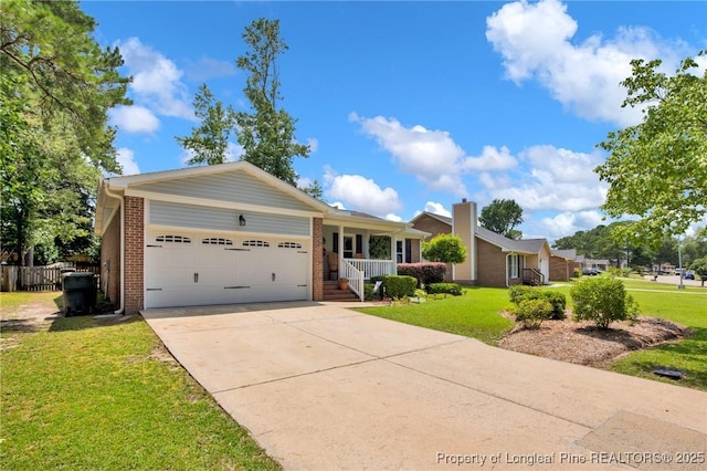 4327 Falls Dr, Hope Mills, NC 28348 - ranch-style house featuring brick siding, an attached garage, driveway, and a chimney