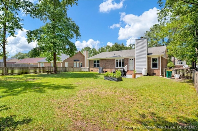 4327 Falls Dr, Hope Mills, NC 28348 - rear view of house with brick siding, a fenced backyard, a chimney, and a patio area