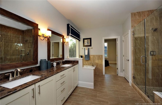 bathroom featuring walk in shower, tile floors, and double vanity