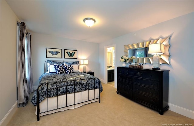 carpeted bedroom featuring connected bathroom