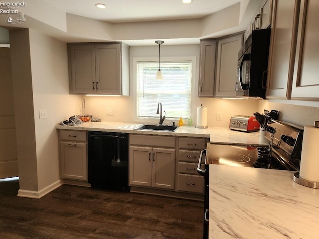 kitchen with dark hardwood / wood-style floors, pendant lighting, sink, gray cabinets, and dishwasher