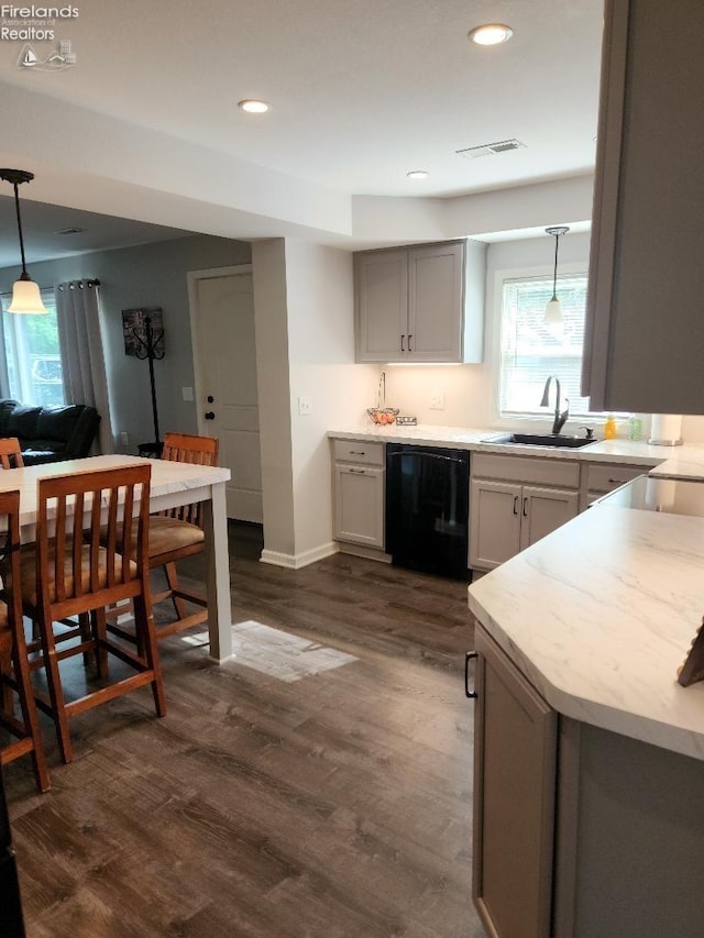 kitchen with dark hardwood / wood-style floors, sink, gray cabinetry, black dishwasher, and decorative light fixtures