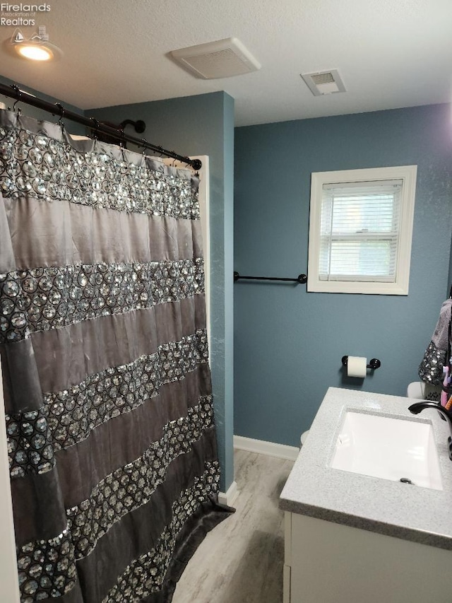 bathroom with vanity and hardwood / wood-style floors