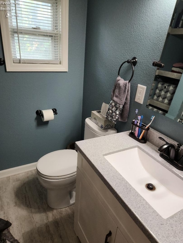 bathroom featuring hardwood / wood-style floors, toilet, and vanity