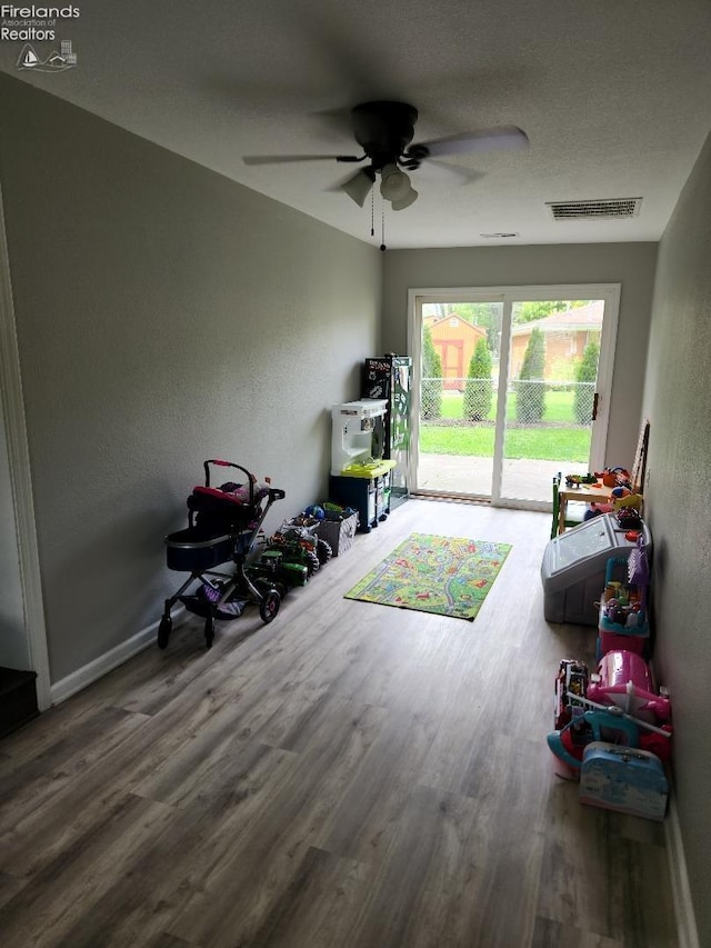 interior space with ceiling fan and hardwood / wood-style floors