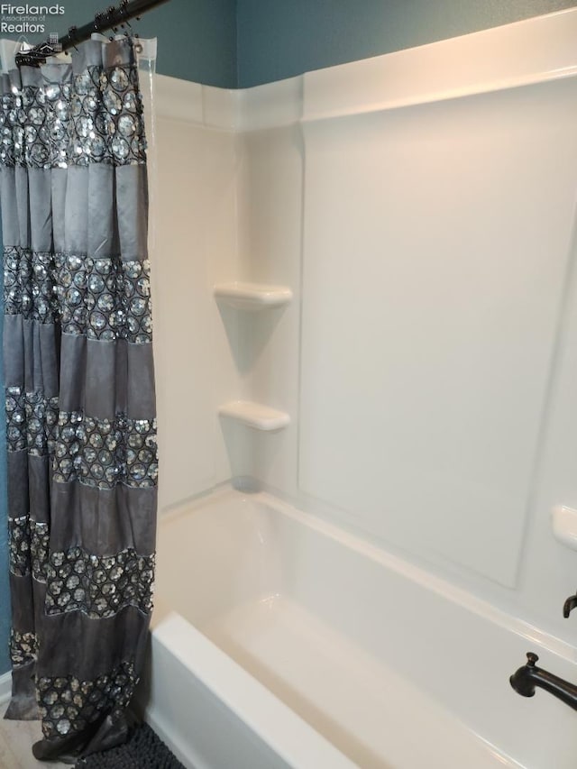 bathroom featuring shower / bath combination with curtain