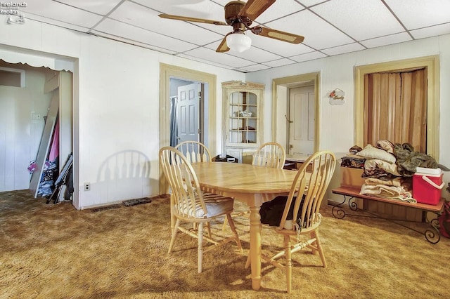 dining room with a paneled ceiling, ceiling fan, and carpet floors