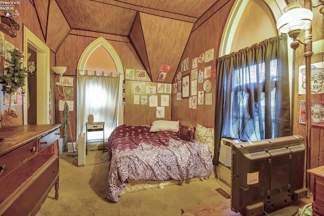 carpeted bedroom with vaulted ceiling, multiple windows, wood walls, and wood ceiling