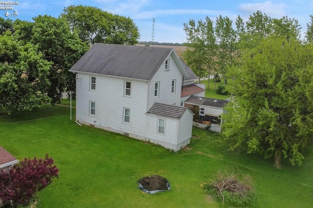 rear view of property with a yard