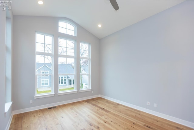 empty room featuring recessed lighting, visible vents, light wood-style floors, vaulted ceiling, and baseboards