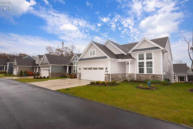 craftsman house with a residential view, stone siding, driveway, and a front lawn