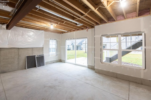 unfurnished living room with concrete floors