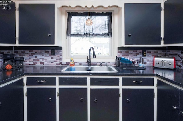 kitchen featuring tasteful backsplash and sink