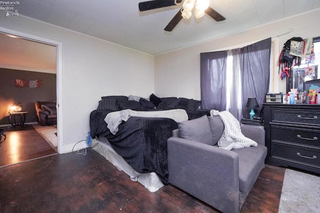 bedroom with ceiling fan, crown molding, and dark wood-type flooring