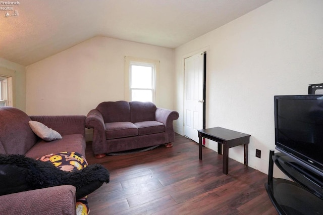 living room featuring dark hardwood / wood-style floors and vaulted ceiling